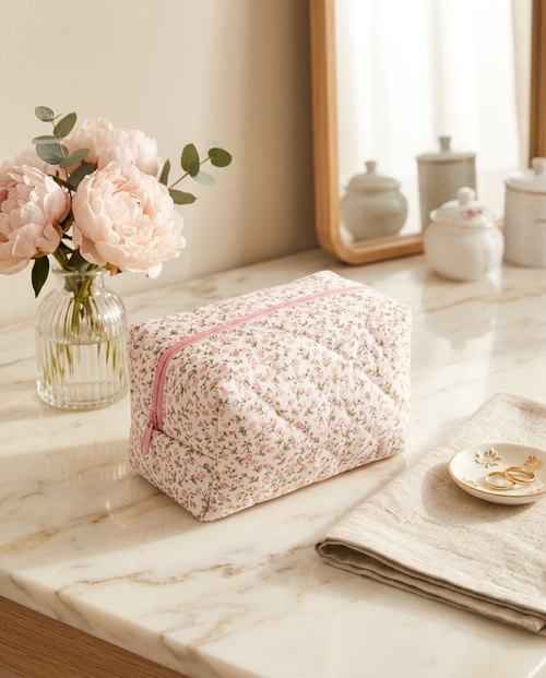 Pouchéa floral makeup bag on a vanity with flowers
